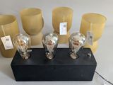 five light bulbs that are sitting on a black block