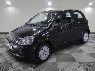 a picture of a small black car parked on a checkered floor