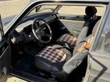a small car with a plaid seat cover and a steering wheel