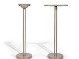 two metal pedestals on a white background with a shadow on the ground