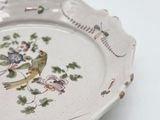 a white plate with a bird and flowers on it