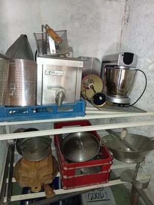 many pots and pans on the shelves in the kitchen