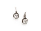 a pair of diamond earrings on a white background