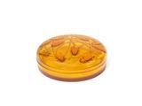 an image of a yellow glass pill case with a flower design on it
