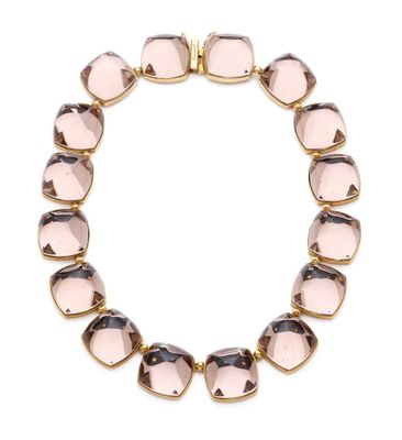a close up of a bracelet with pink glass beads on a white background