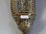 an old silver vase with a tag on it sitting on a table