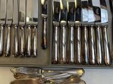 a lot of knives and spoons that are in a box