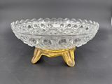 a glass bowl that is on a stand on a table