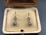 an image of a pair of earrings in a box on a table