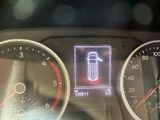 a picture of a car dashboard with a car light on