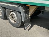 un semi-remorque vert et blanc à plateau