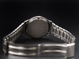 a silver watch that is sitting on a table