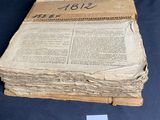a stack of old books on a table with a price tag