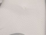 a white pillow that is on top of a bed