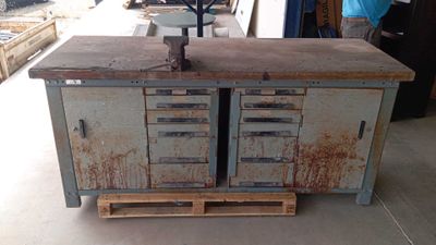 an old metal cabinet with drawers and a clock on top