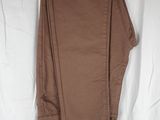 the pants are hanging on a hanger on a white sheet