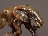 a statue of an elephant that is standing on a rock