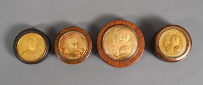three gold and silver medallions of a man and a woman