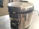 a silver and black food warmer sitting on a table