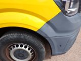 a yellow and gray van parked on the side of the road