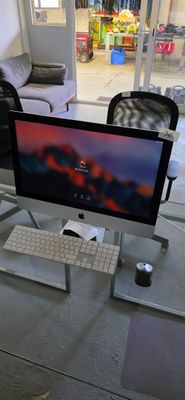 a desk with a computer monitor and keyboard on it