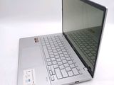 a silver laptop with a black keyboard on a white surface