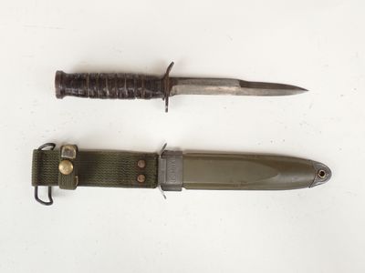 two knives that are laying next to each other on a table