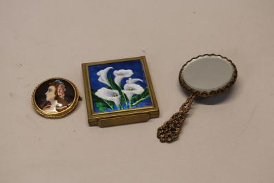 a picture of a mirror, a picture of a woman, and a necklace on a table