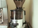 a coffee grinder sitting on a counter next to a coffee maker