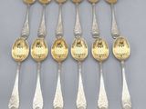 a set of eight silver and gold plated spoons