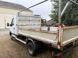 a white truck that is parked in the grass