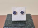 a pair of blue sapphire earrings sitting on top of a marble block