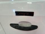 a sticker on the door handle of a white car