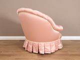 a pink chair with a ruffled skirt on it