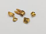 three pieces of gold plated metal on a white surface