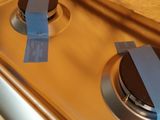 a close up of a stove with tape on the burner