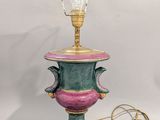 a green and pink lamp with a light bulb on it