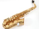 a close up of a gold saxophone on a white background