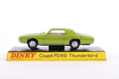 a green toy car sitting on top of a box
