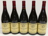 six bouteilles de vin sont alignées sur une surface blanche