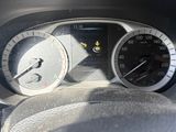 a close up of a car dashboard with a speedometer and a steering wheel
