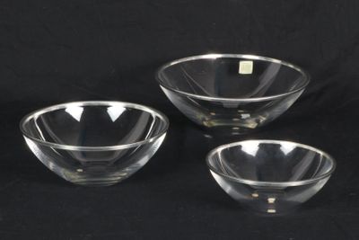 three clear glass bowls sitting on top of a black surface