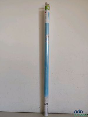 a close up of a pencil on a table next to a wall