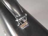 a close up of a black leather bag with a metal clasp