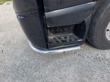 a close up of a black truck with a flat tire