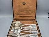a set of six silverplated flatware in a leather case