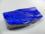 a close up of a blue stone on a white surface
