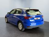 the rear end of a blue car parked in a showroom