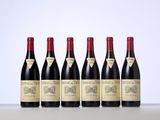 six bottles of red wine lined up in a row