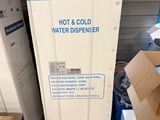 a box of hot and cold water dispenser sitting on a pallet